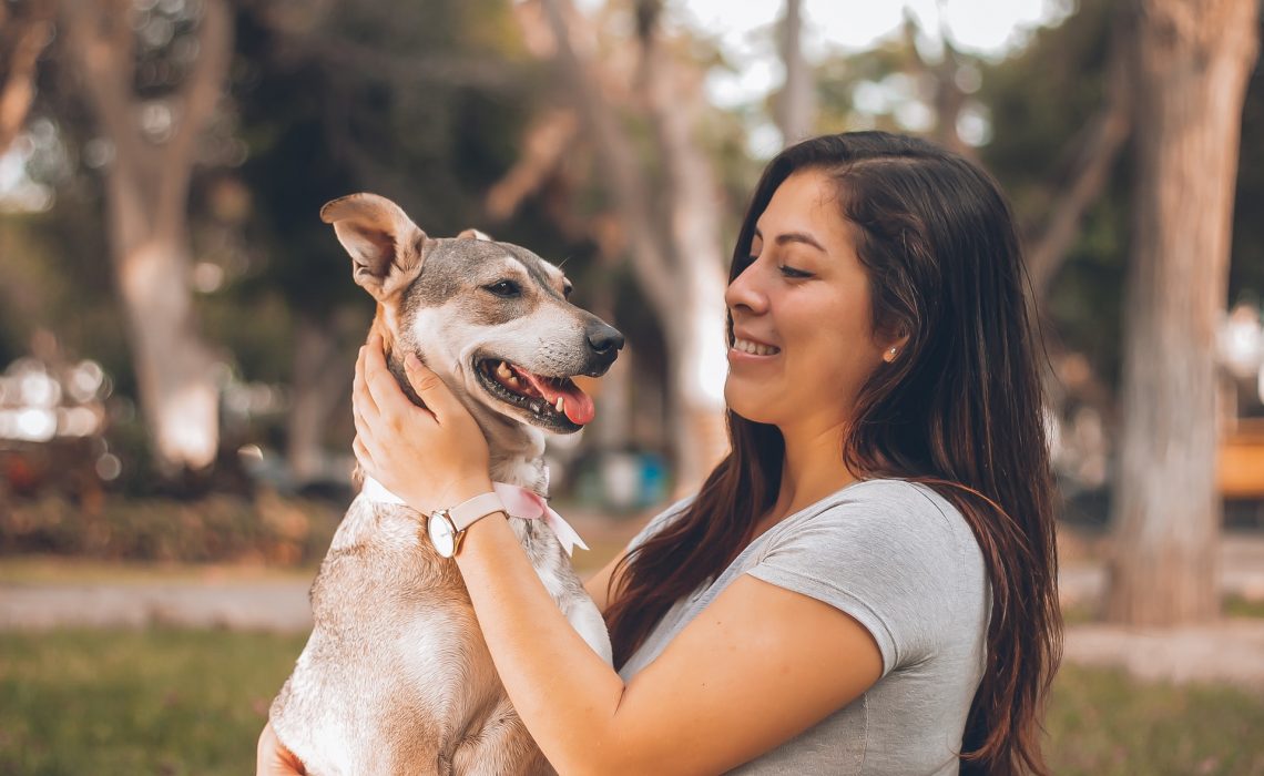 Woman playing with a dog outside