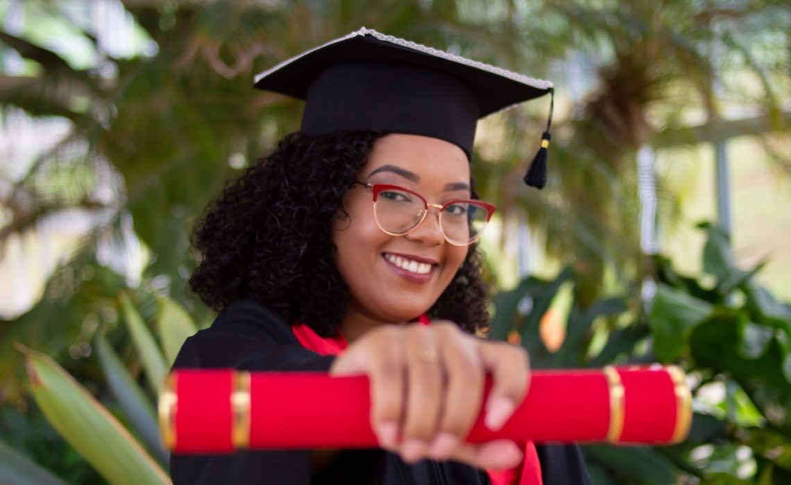 smiling woman wearing academic dress and black academic hat photo