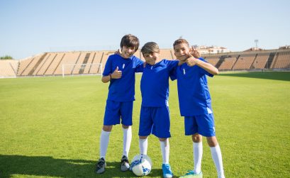 Boys in Their Sports Team Uniform Standing in the Soccer Field