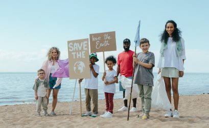 Community trash pick up group standing together at the beach