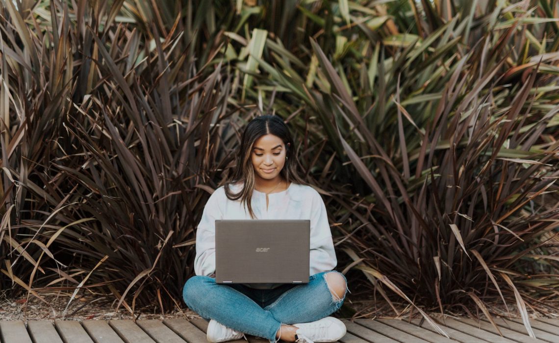 women on her laptop sitting outside