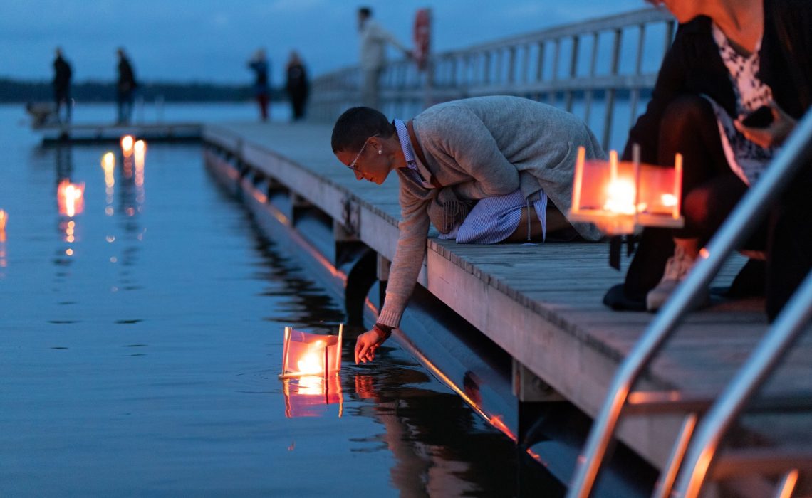 Woman and a lantern at a memorial