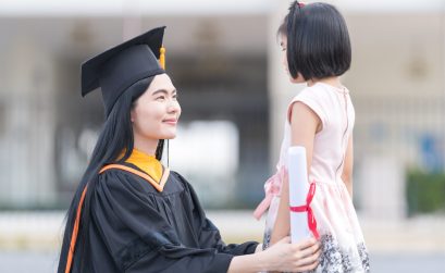 Southeast Asian woman graduate with a little girl on her graduation day in Thailand