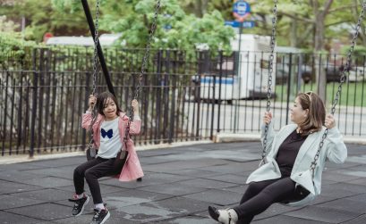 Mother and daughter with disabilities at an accessible playground