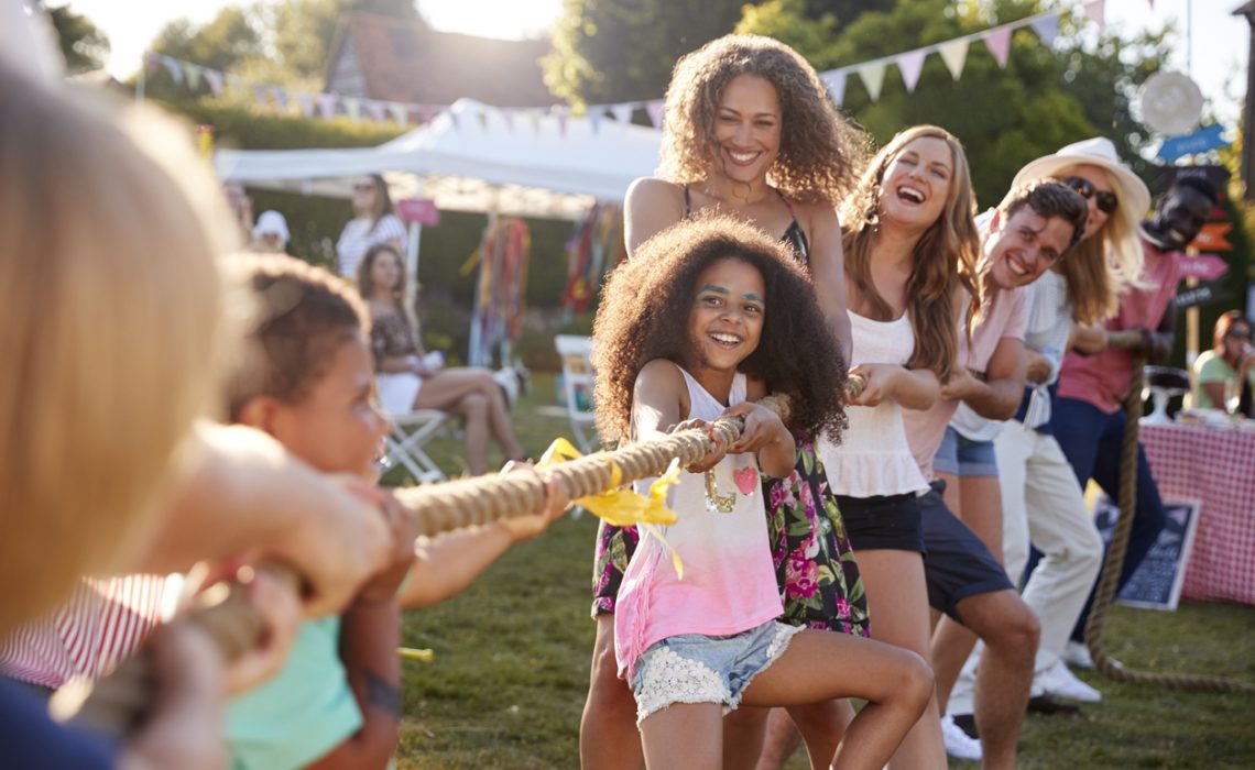 Game Of Tug Of War At Summer Garden Fundraising Event