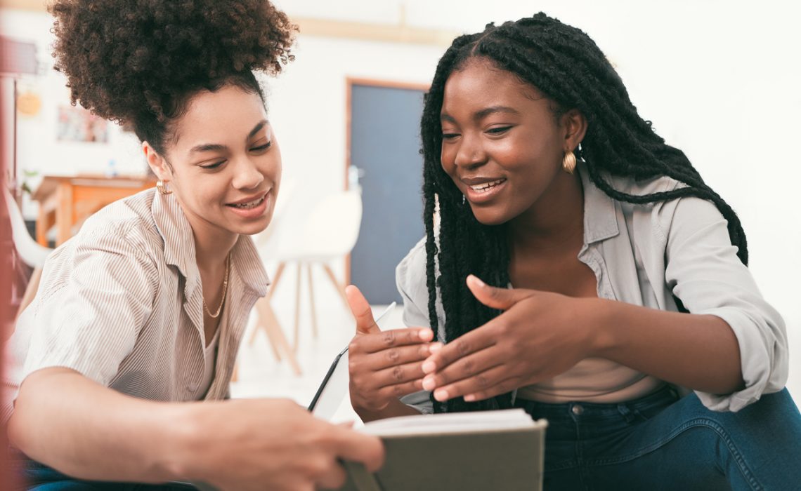 Talking, planning and collaboration of female university students working on a group project. Teamwork of young women discussing a team study strategy together for a school presentation for college