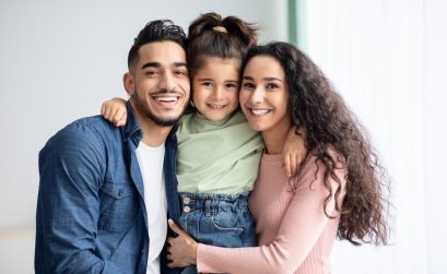 Portrait Of Happy Middle Eastern Family Of Three Posing Together At Home