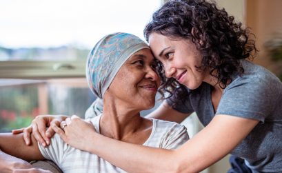 Female cancer patient hugs adult daughter